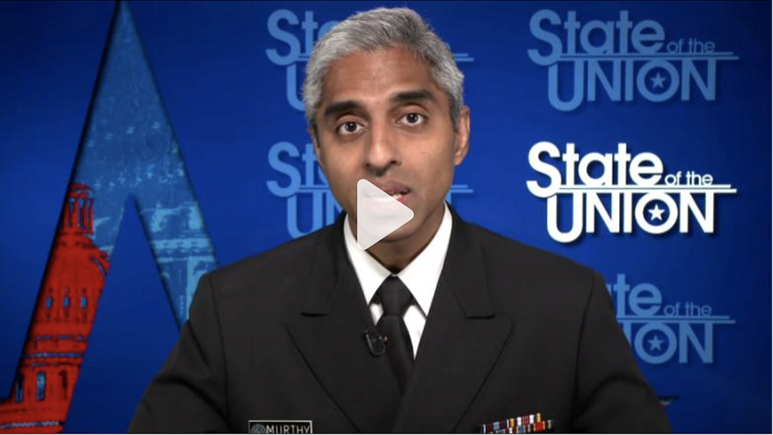 Male with grey hair in U.S. Surgeon General uniform sitting in front of a blue backdrop with the words "State of the Union" repeated; play button hovering over face