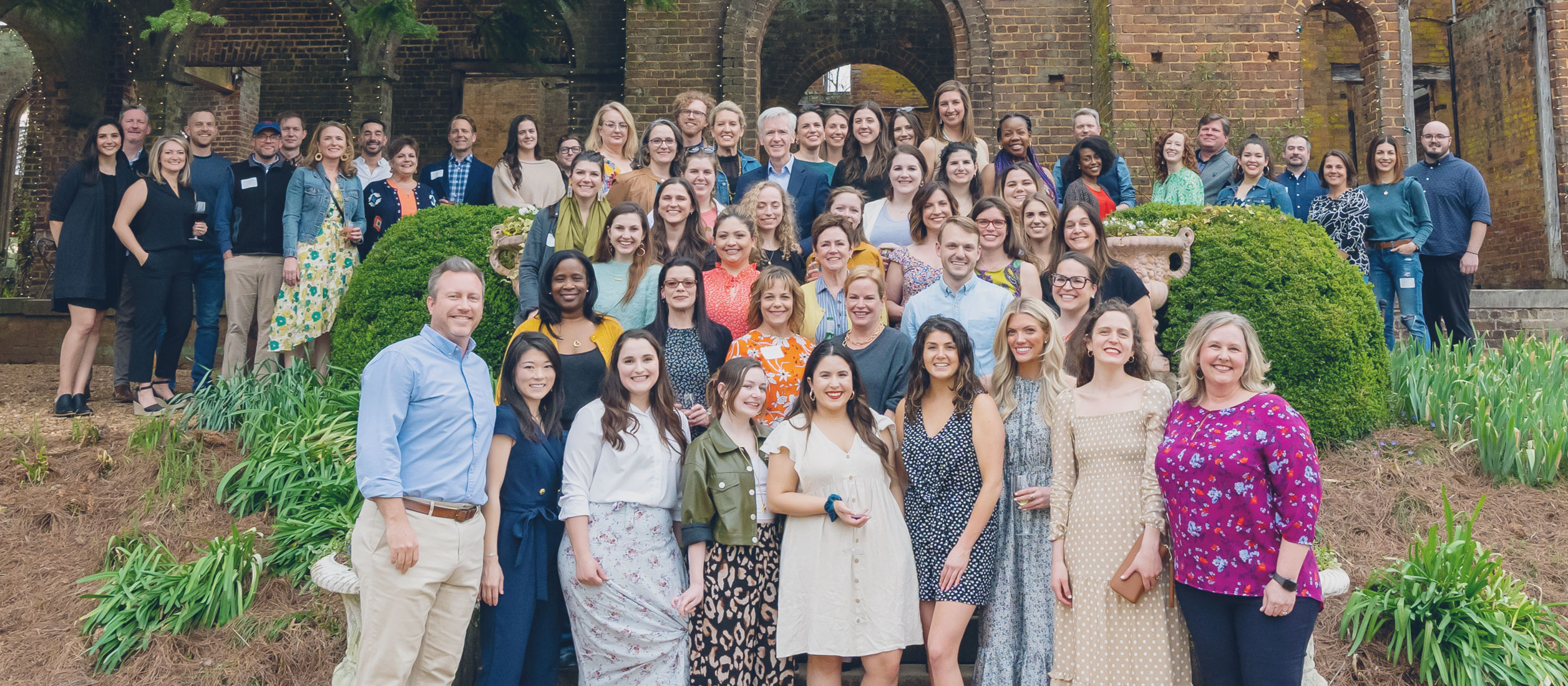 A large group photo of people dressed in business casual attire