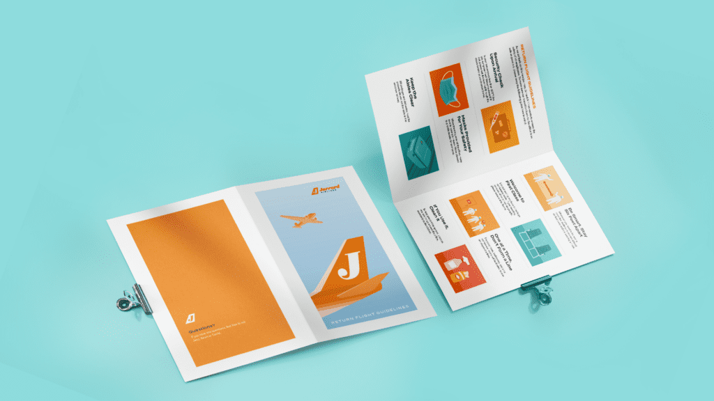 Two Jarrard brochures, opened to different pages and both clipped with a metal clipboard clip