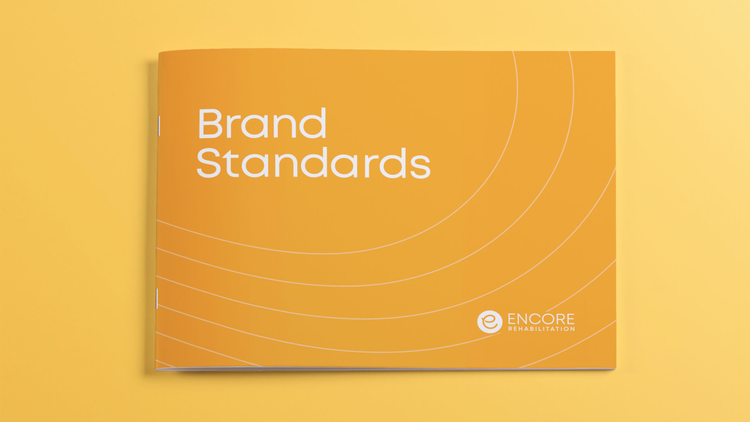 Encore-Brand-Guide-Cover-scaled A Brand Standards booklet for "Encore Rehabilitation" on a yellow background