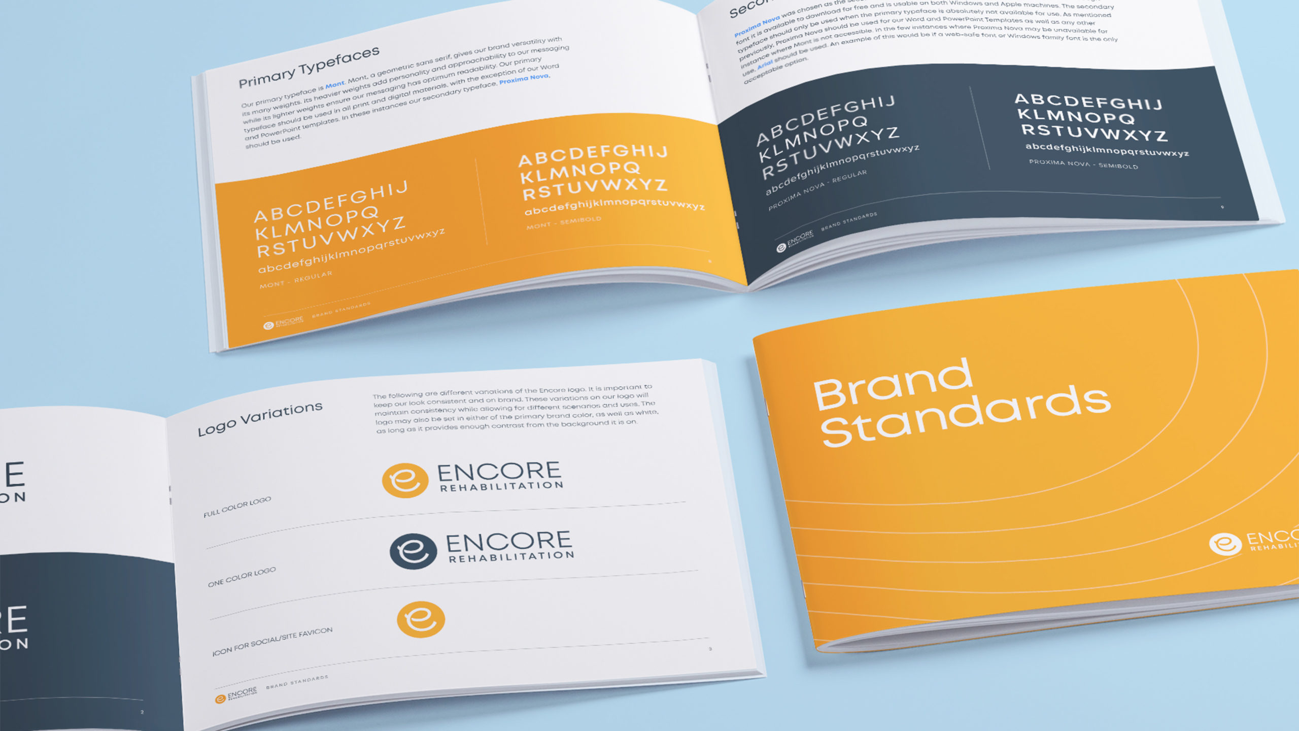 Encore-Brand-Guide-scaled Three brand guide booklets laid out on a blue background, all featuring different pages