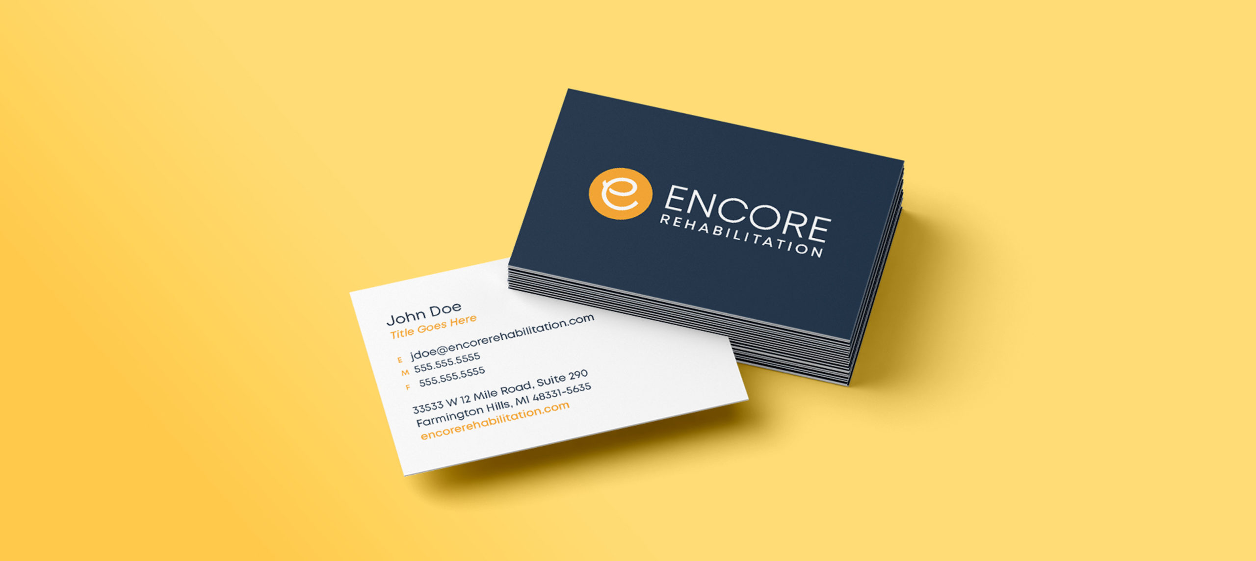 Encore-Business-Cards--scaled A stack of business cards with one poking out on a yellow background