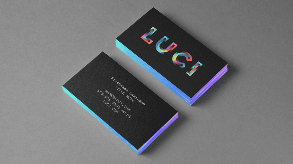 Two stacks of black LUCI business cards, with one stack showing the backside of the cards and the other stack showing the front side of the cards