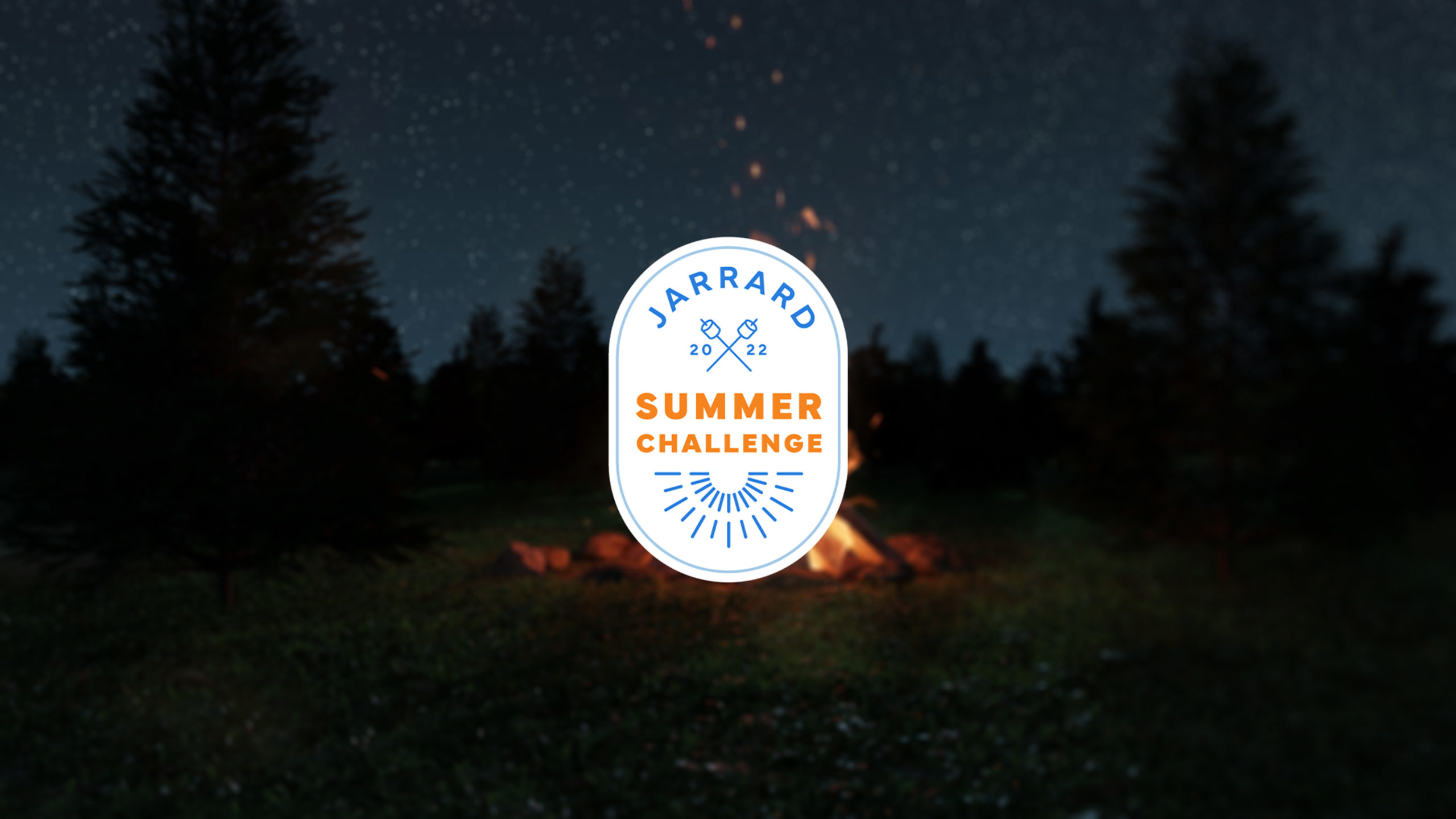 Summer-Challenge-Logo-scaled An oval white logo that reads "Jarrard 2022 Summer Challenge" on a campfire and starry night background